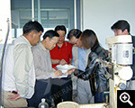 Xinhai president Zhang Yunlong with clients viewed products from experiments