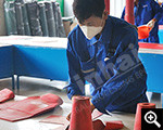Worker is cutting wear-resistant rubber plate